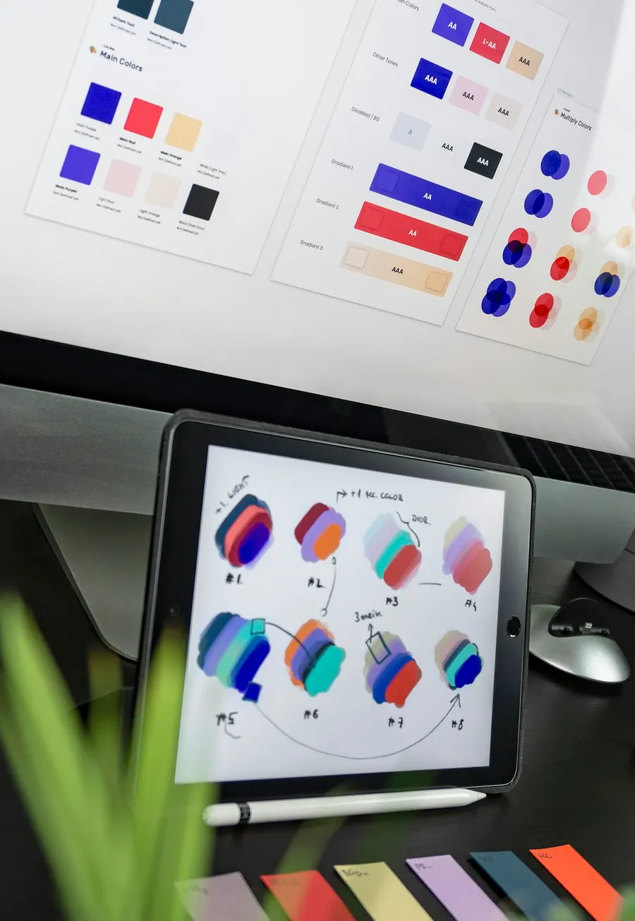 Tablet showing color studies beside a palette board